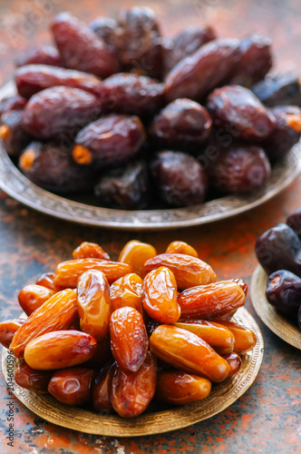 Set of various of dried dates or kurma in a vintage plates.