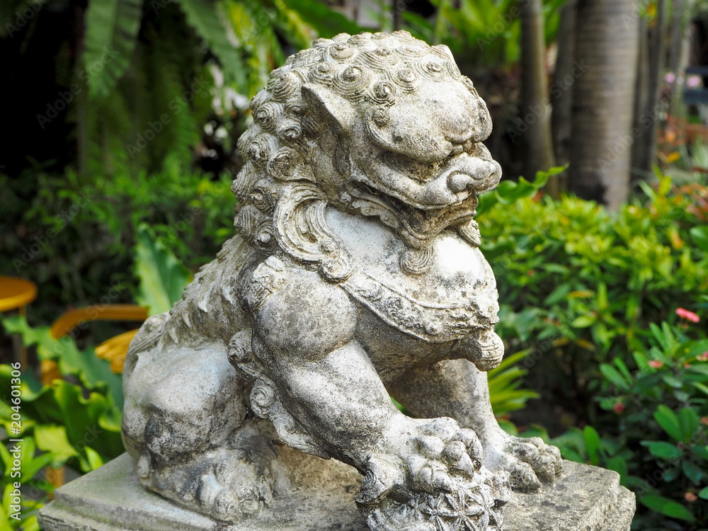 Traditional Guardian Lion Sandstone Statue in the City Park