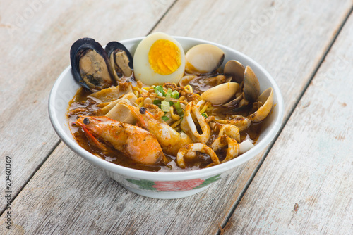 seafood curry noodle with wood background