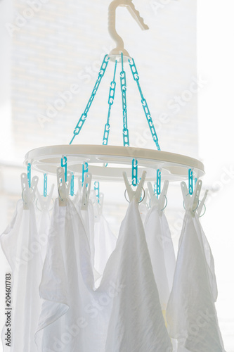 Baby cotton diapers hanging on plastic white cloth clamp for sun drying clothes. Healthcare concept. photo