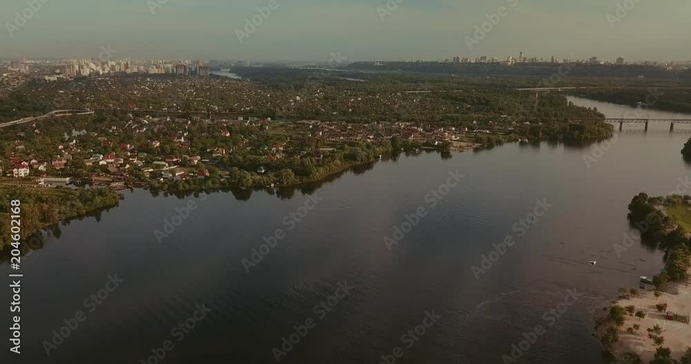 Aerial View. Flight over the river overlooking the bridge city. Sunny Day Aerial View. Flight over the river overlooking the bridge city. Sunny Day