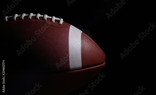 American Football Against a Black Background with Copyspace to the Right
