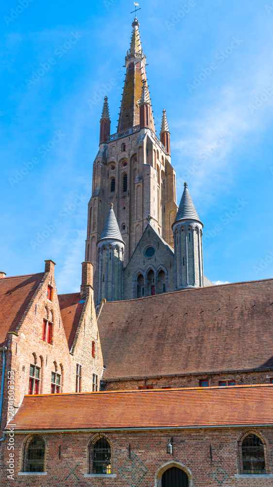 Fototapeta premium Tower of the church of Our Lady in Bruges, Belguim - upward view