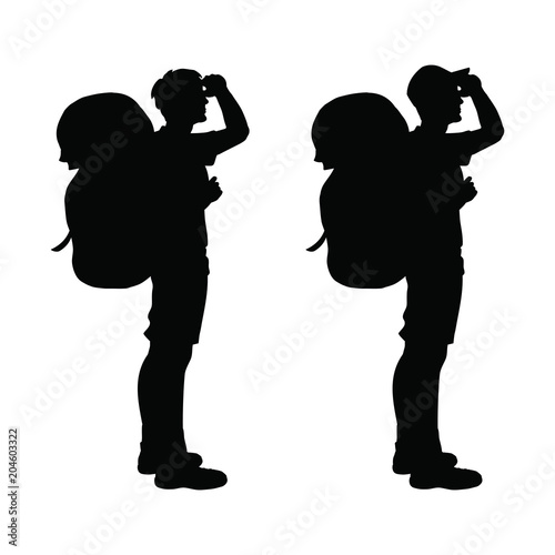 Isolated silhouette of a hiker looking on the sun