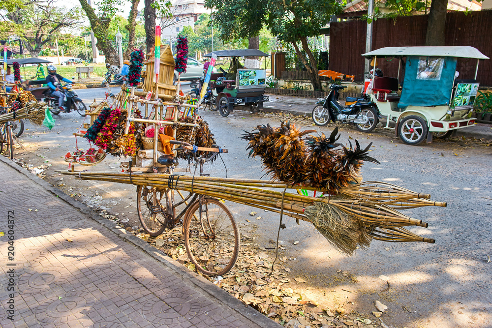Fototapeta premium Cambodian bicycle with a lot of items for cleaning use like feathers, brooms