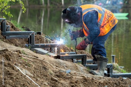 Electric welding of a metal ladder