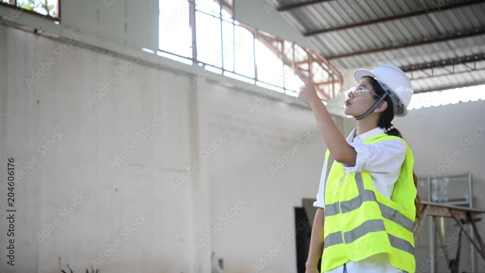 Engineer woman working at site of building under construction Engineer woman working at site of building under construction