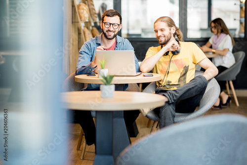 Men working in the cafe