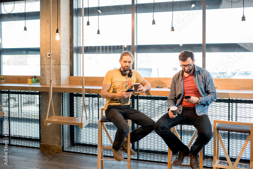 Men with smartphonees in the cafe photo