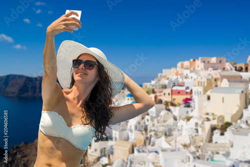 Woman  taking a selfie  in Santorini