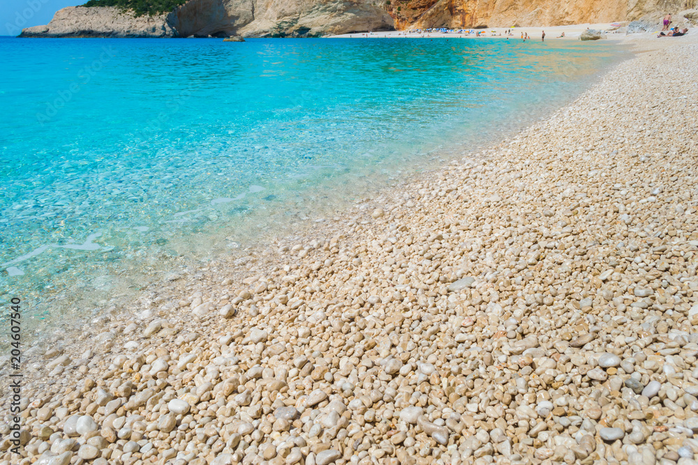Obraz premium A pebble beach with turquoise waters. Summer holidays concept.