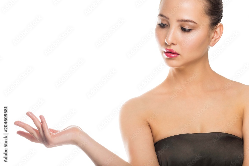 Naklejka premium Woman showing product. Beautiful girl pointing to the side presenting your product.