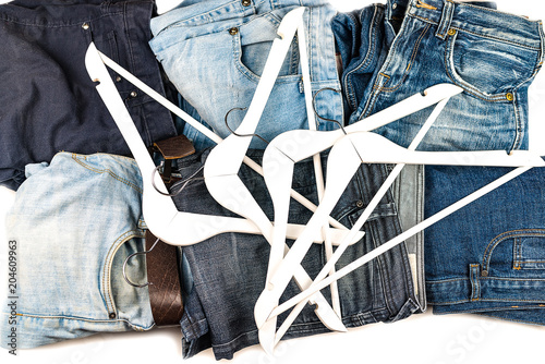 Different blue and light men's jeans and hangers photo