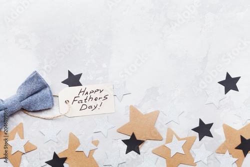 Wallpaper Mural Happy Fathers Day background with greeting tag, bowtie and star confetti on table top view. Flat lay composition. Torontodigital.ca