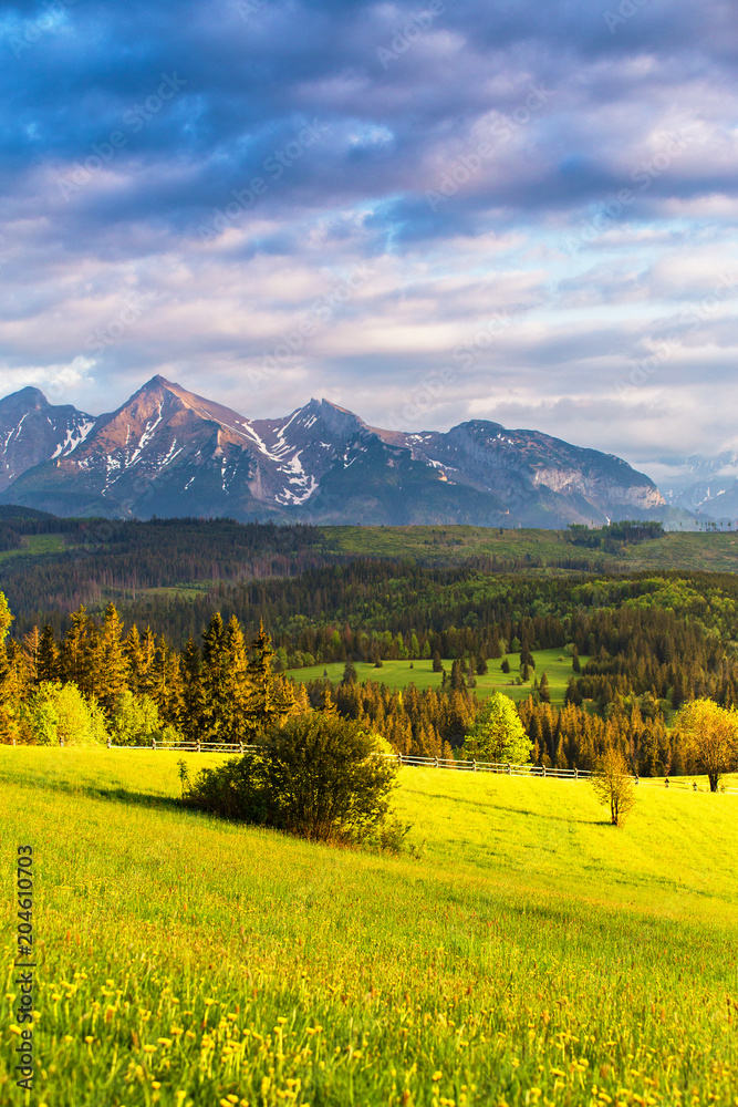 Sunset in Tatra Mountains, Poland. Mountain ridge over cloudy sky