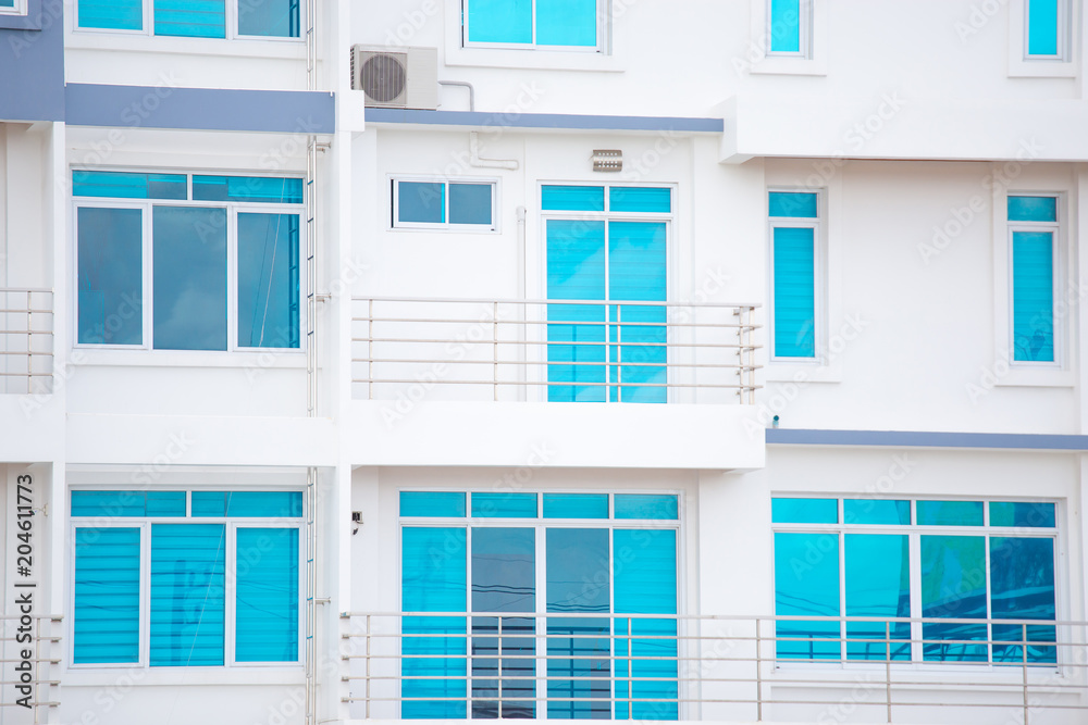 Blue modern windows on white contemperary condominium or building