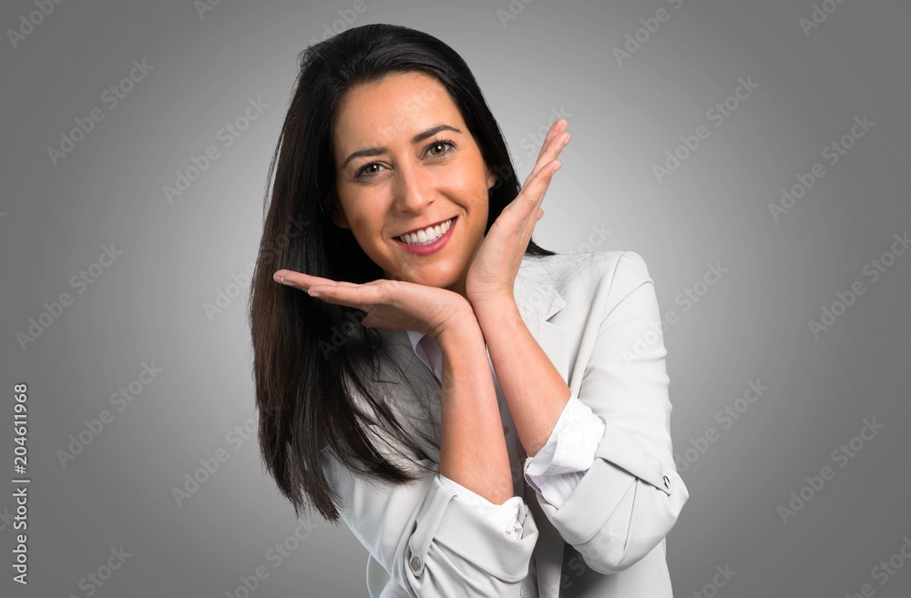 Happy pretty woman on grey background Happy pretty woman on grey background