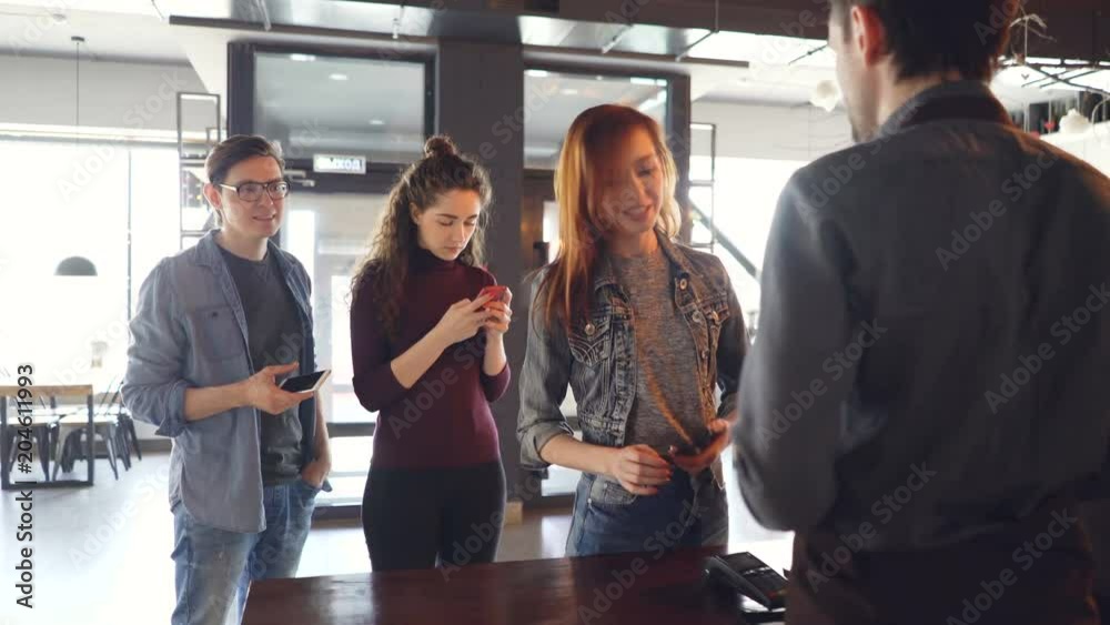 люди в офисной одежде стоят в очереди за кофе, глядя в телефоны