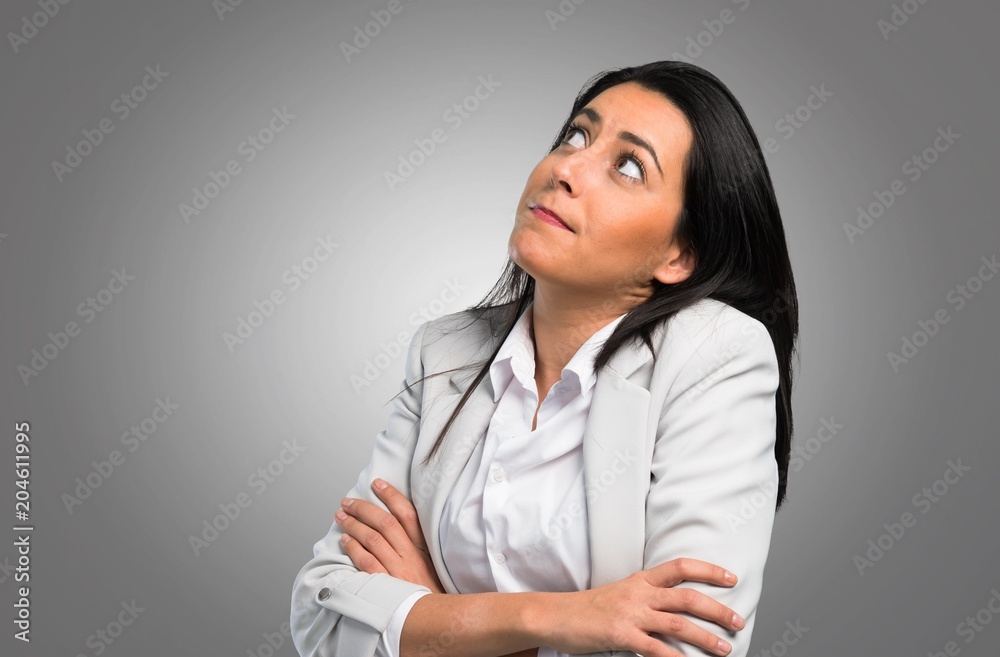 Pretty woman making unimportant gesture on grey background Pretty woman making unimportant gesture on grey background