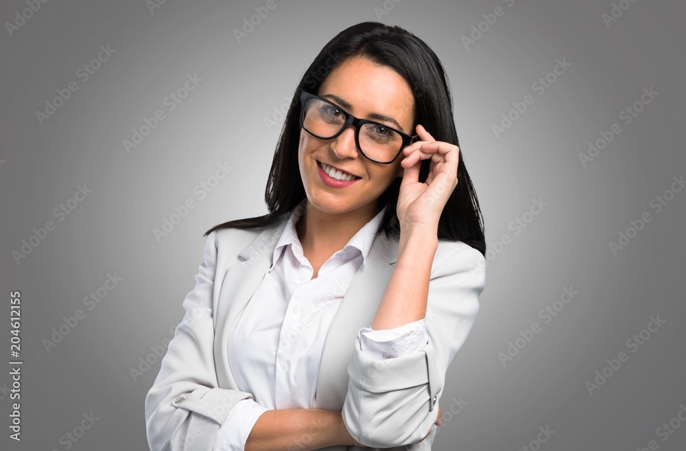 Happy pretty woman with glasses on grey background Happy pretty woman with glasses on grey background