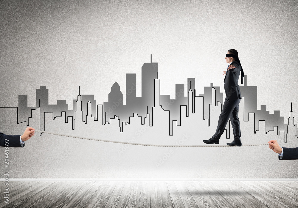 Business concept of risk support and assistance with man balancing on rope Business concept of risk support and assistance with man balancing on rope