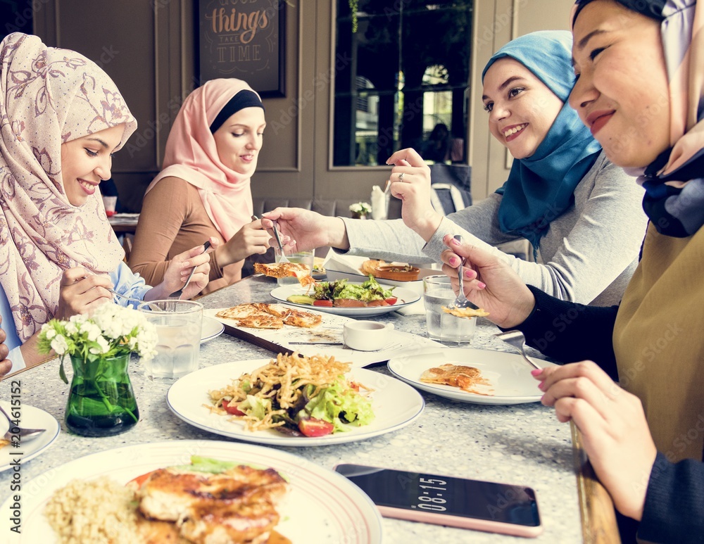 Islamic women friends dining together with happiness Islamic women friends dining together with happiness
