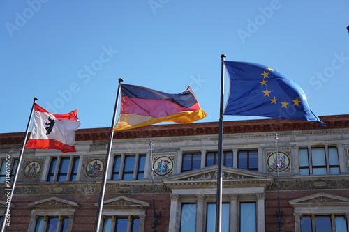 Flags of Berlin, of Germany and of the European Union fluttering