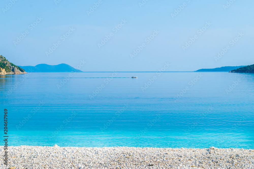A beach with blue crystal sea waters in Poros in Lefkada Ionian island, Greece