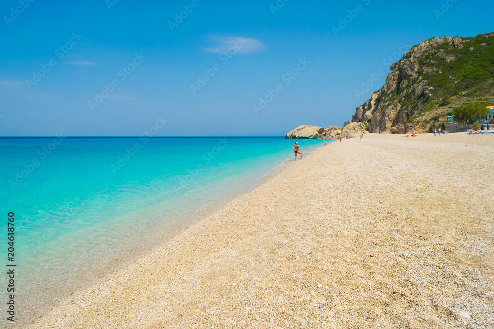 Crystal clear turquoise sea waters of a pebble beach. Kathisma beach in Lefkada ionian island in Greece Crystal clear turquoise sea waters of a pebble beach. Kathisma beach in Lefkada ionian island in Greece