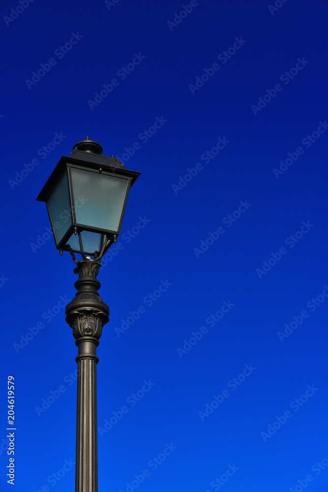 Old fashioned street lamp against blue sky (with copy space)
