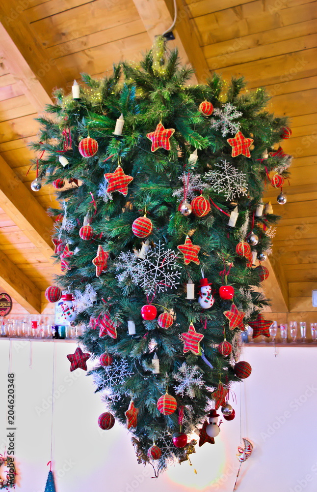 Christmas tree hanging from a wooden ceiling Stock Photo
