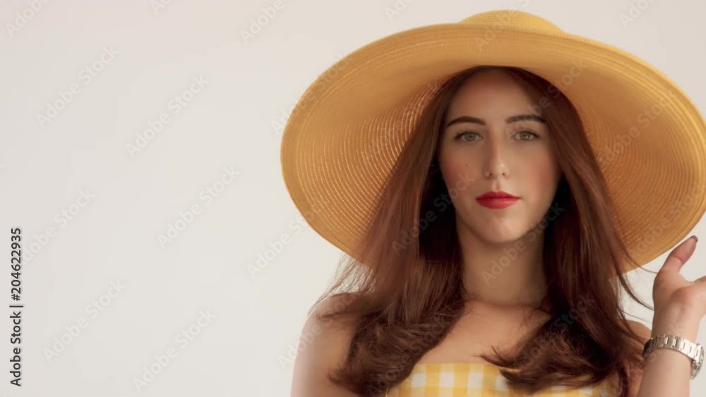 closeup portrait of woman with large straight hair wears big summer yelow hat. wOMAN IN HAT SUMMER VIBES, CLOSEUP PORTRAIT. sLOWMOTION BLOWING HAIR closeup portrait of woman with large straight hair wears big summer yelow hat. wOMAN IN HAT SUMMER VIBES, CLOSEUP PORTRAIT. sLOWMOTION BLOWING HAIR