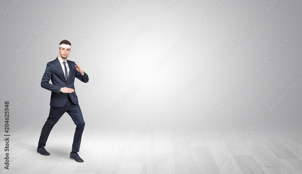 Young businessman in suit fighting in an empty space
Young businessman in suit fighting in an empty space