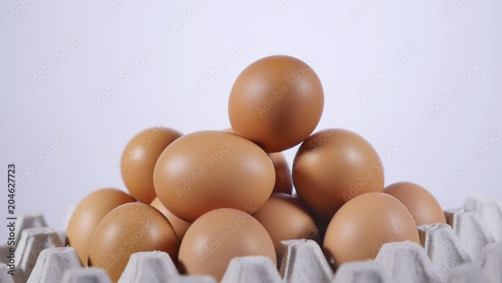eggs stacked pyramid in a cardboard tray, Hand takes one egg eggs stacked pyramid in a cardboard tray, Hand takes one egg