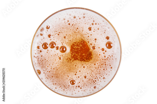 Beer in glass. Lager draft beer foam on white background. View from above.