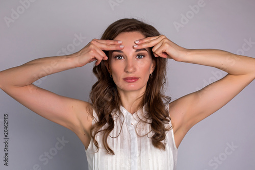 young woman makes herself a massage complex of exercises