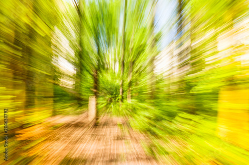 Eco background. Ecology Abstract image of tree in countryside. Created by zooming out while closing shutter. Zoom speed blured motion.
