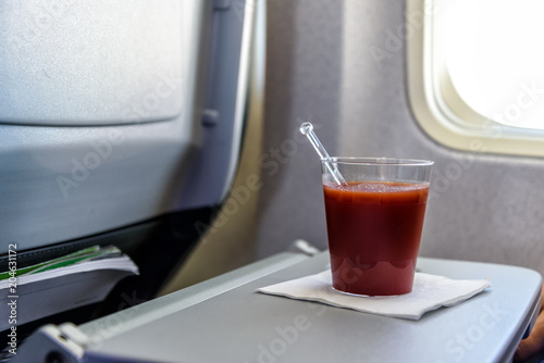 Glas mit Tomatensaft an Bord eines Flugzeugs