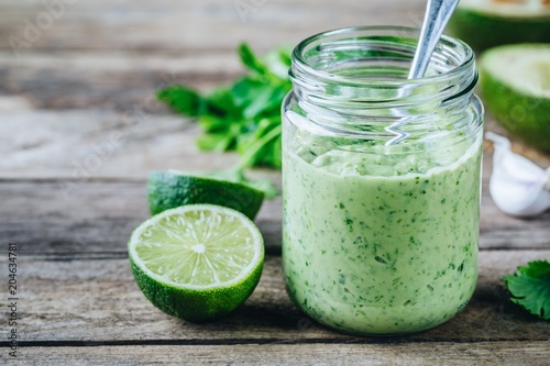Wallpaper Mural green salad dressing with avocado, lime and cilantro in a glass jar