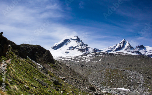 hiking trail leading to snow-capped peaks with a great view of the Gran Paradiso national Park in the Italian Alps