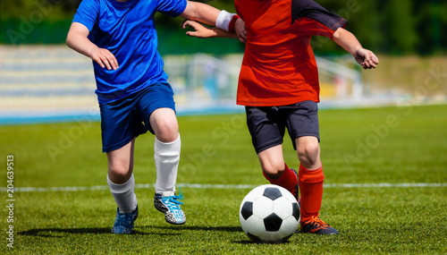 Fototapeta Naklejka Na Ścianę i Meble -  Kids teams playing soccer football match on a sports field