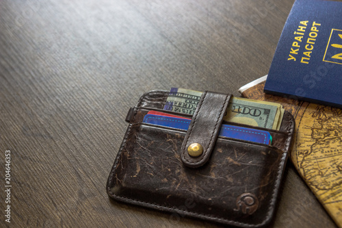 Passport and money for travel summer on wooden table