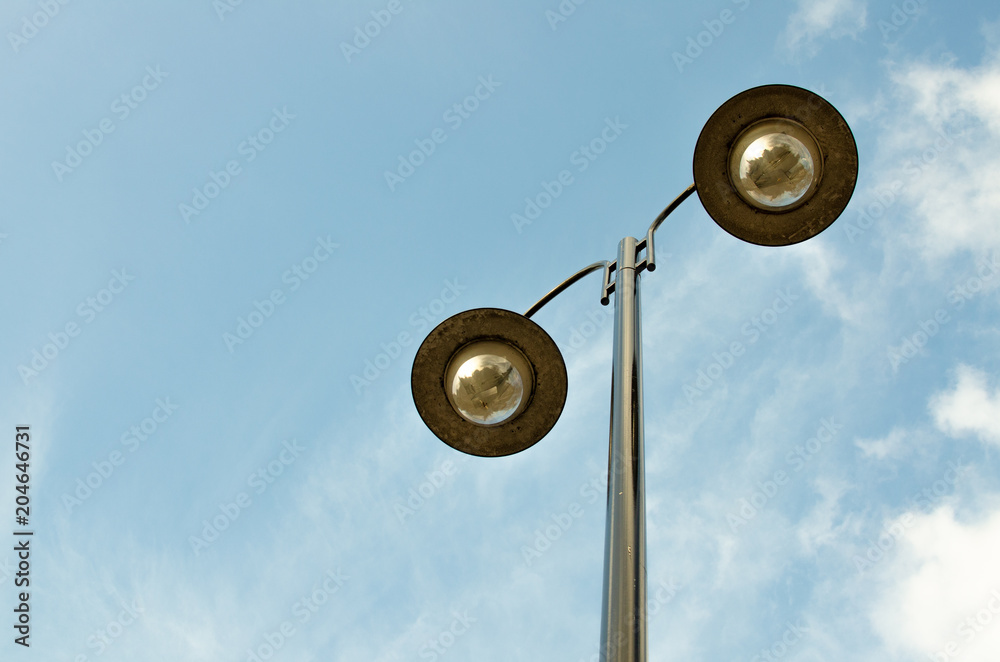 Low angle view of street lights during the day against the sky Low angle view of street lights during the day against the sky