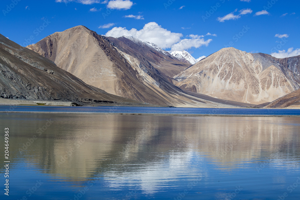 Himalayas Mountains with Pangong tso lake and blue sky with white clouds, Ladakh, Jammu and Kashmir, India