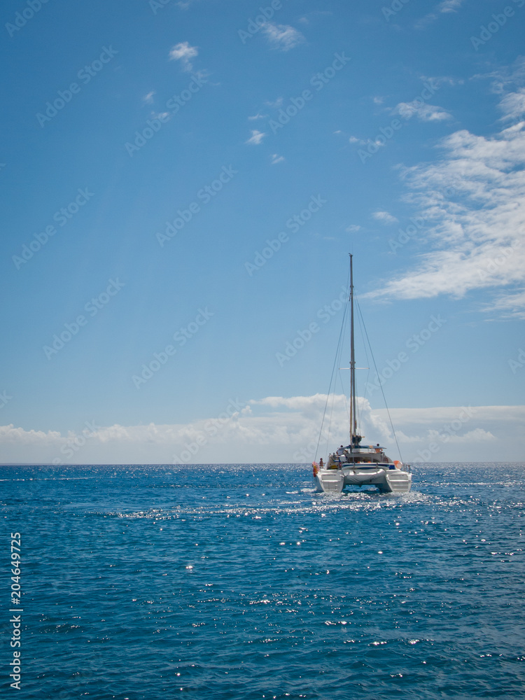 Small private Yacht boat out at sea on the coast of Lanzarote Small private Yacht boat out at sea on the coast of Lanzarote