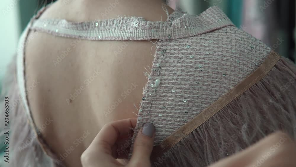 Young fashion designer, tailor and dressmaker customize clothes for the client
