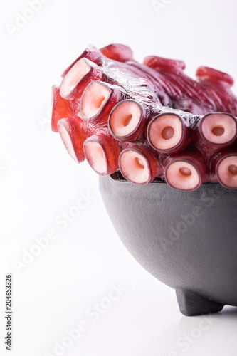 Beautiful octopus tentacle in the black bowl