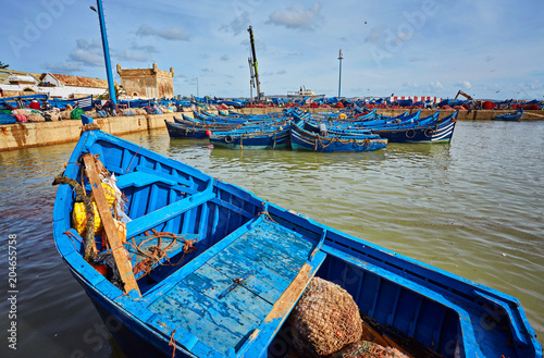 Moroccan blue fishing boats in a row in the port of Essaouira photo