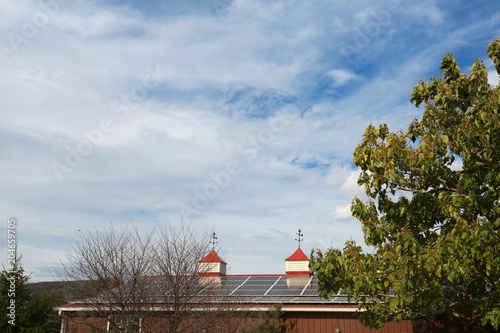 Solar Collectors on the Roof of a Farmhouse in a Sunny Day in Virginia photo