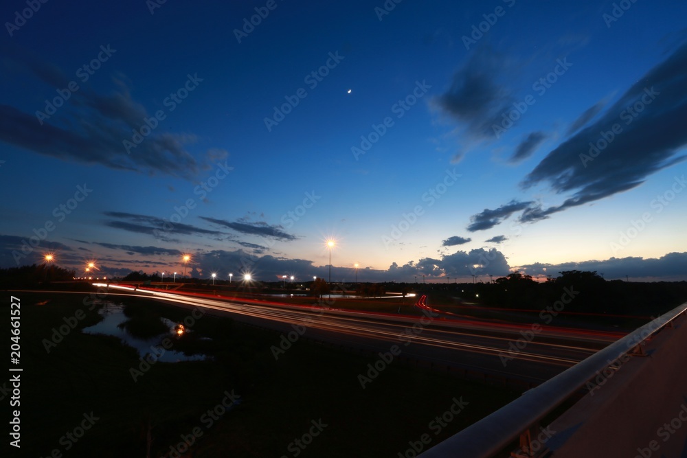 Time Exposure of Rush Hour Traffic on the Florida Turnpike at the Sample Road Overpass in Pompano Beach After Dusk in Twilight Time Exposure of Rush Hour Traffic on the Florida Turnpike at the Sample Road Overpass in Pompano Beach After Dusk in Twilight